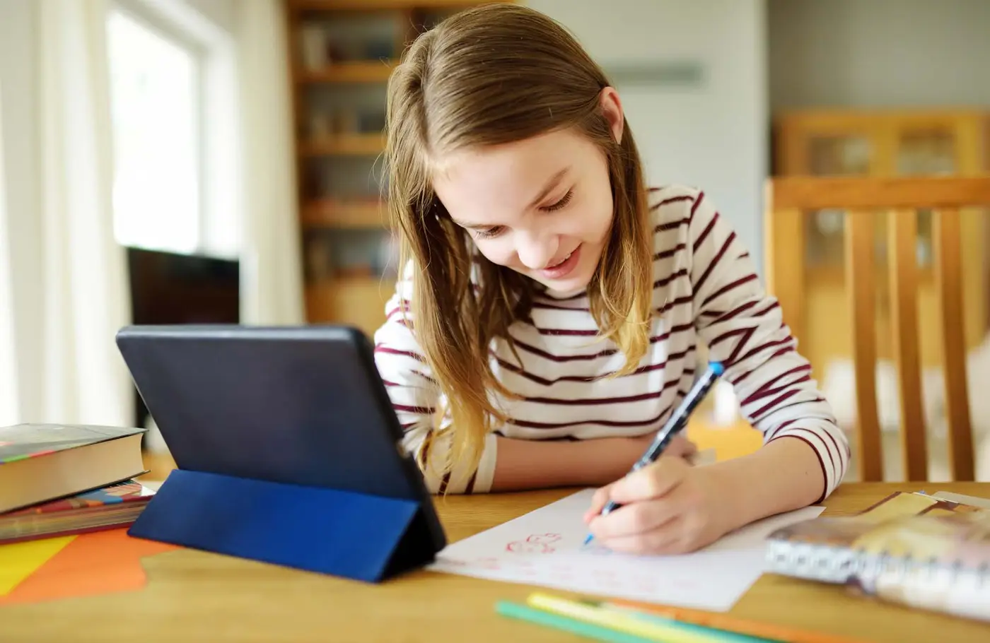 Happy girl learning at table